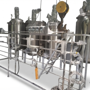 Large-scale industrial fermentation plant with massive stainless steel bioreactor towers and piping networks.