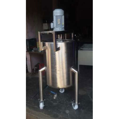 Large industrial SS mixing tank with a conical bottom and top-mounted motor.